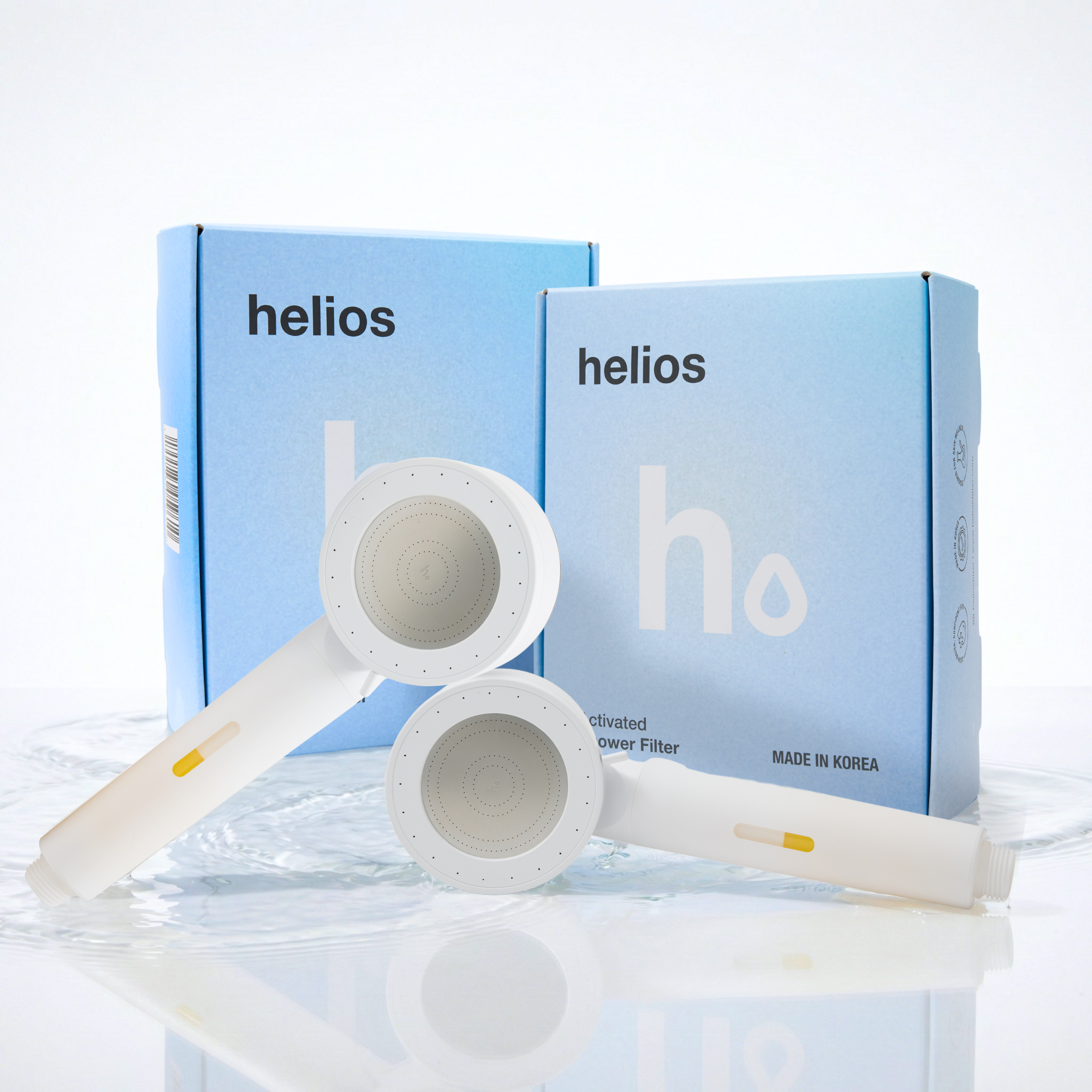 Two Helios Showerhead Filters with branded boxes