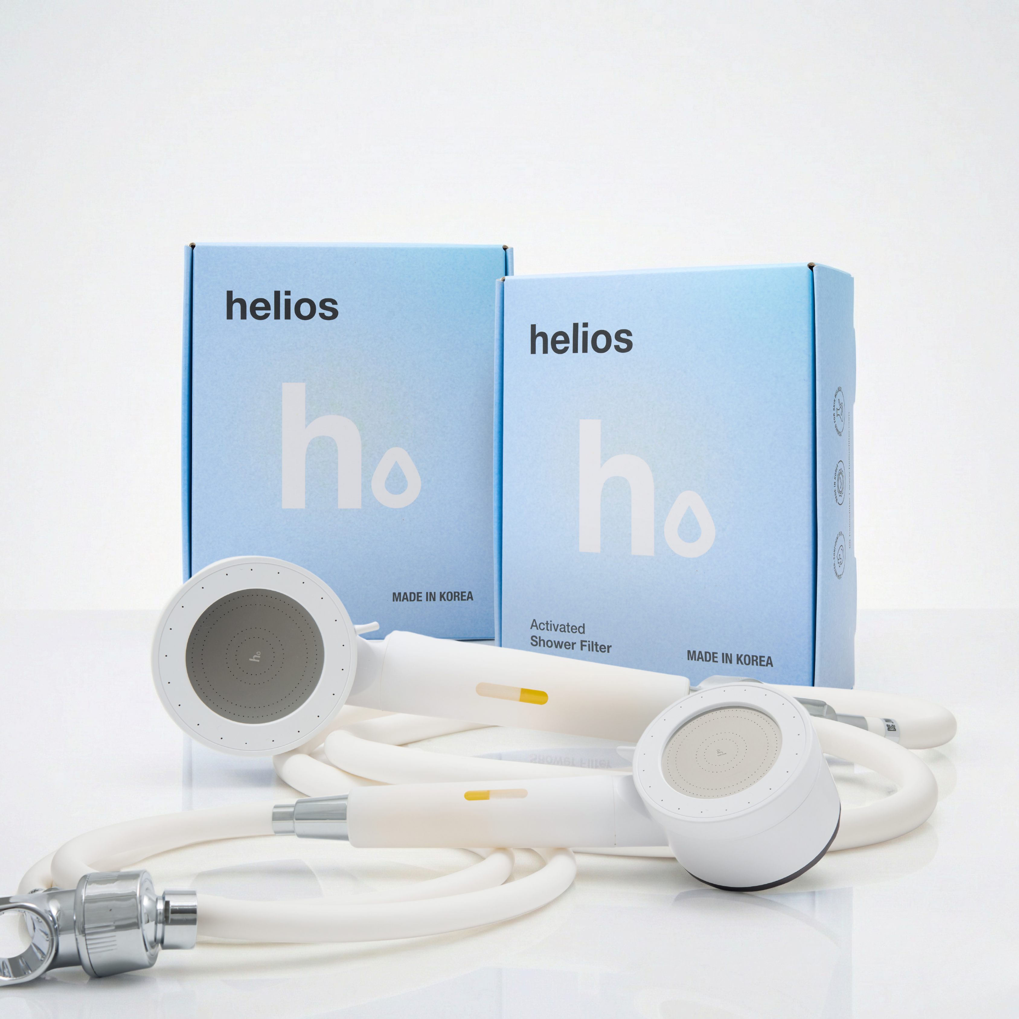 Two Helios Showerhead Filters with branded boxes