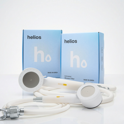 Two Helios Showerhead Filters with branded boxes